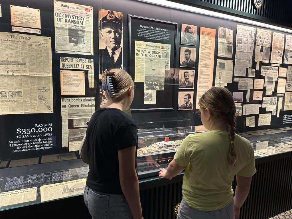 Our girls looking at the 'Special Relationship' exhibition. Old newspaper clippings are mounted behind a glass case