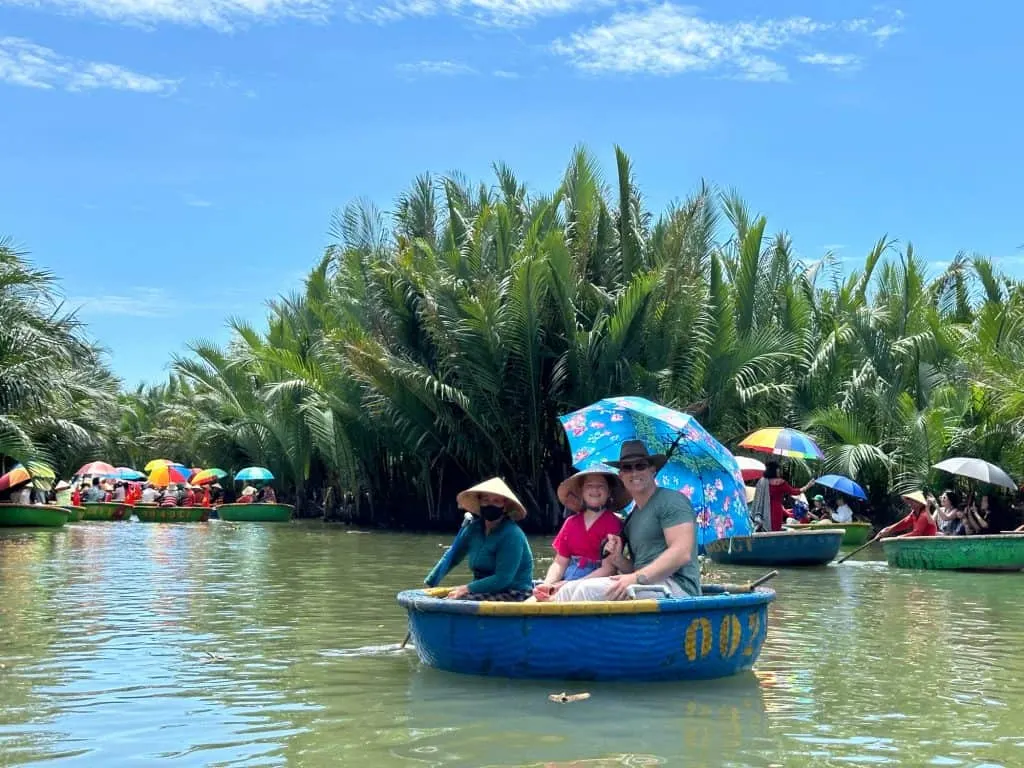 Mr Tin Box and our nine-year-old in a bucket boat being rowed around a lake