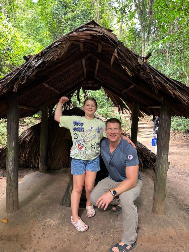 Mr Tin Box and our nine-year-old stood triumphantly at the exit of the Cu Chi tunnels