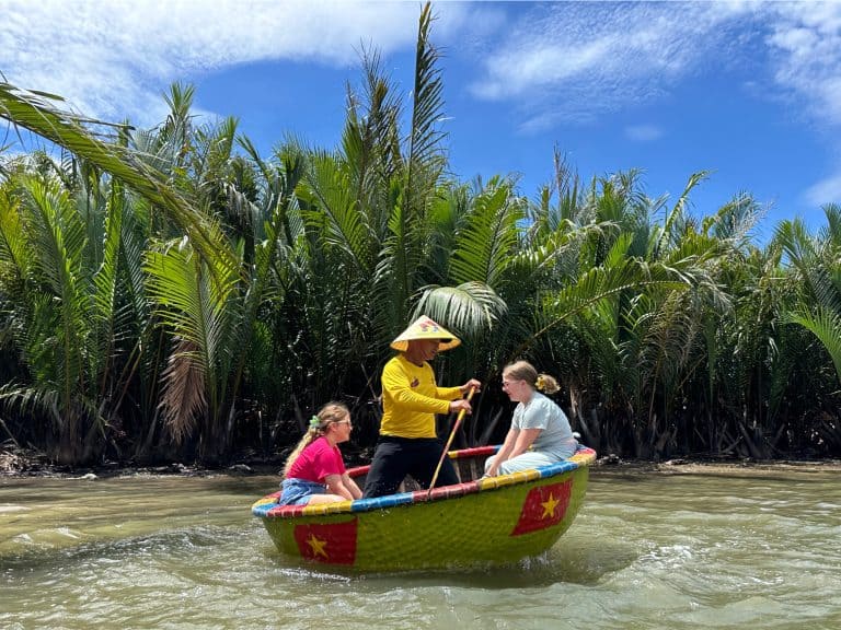 Our daughters sat in a spinning bucket boat in the coconut jungle near Hoi An