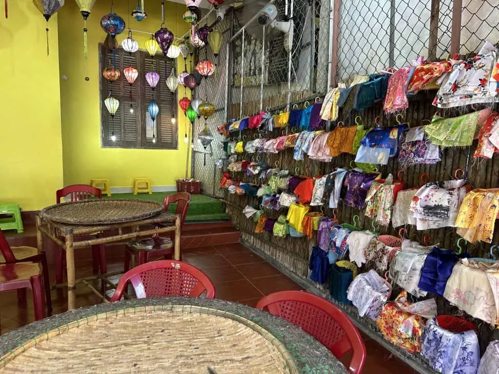 Baskets of colourful materials hanging from a wall in the Lantern Lady's shop