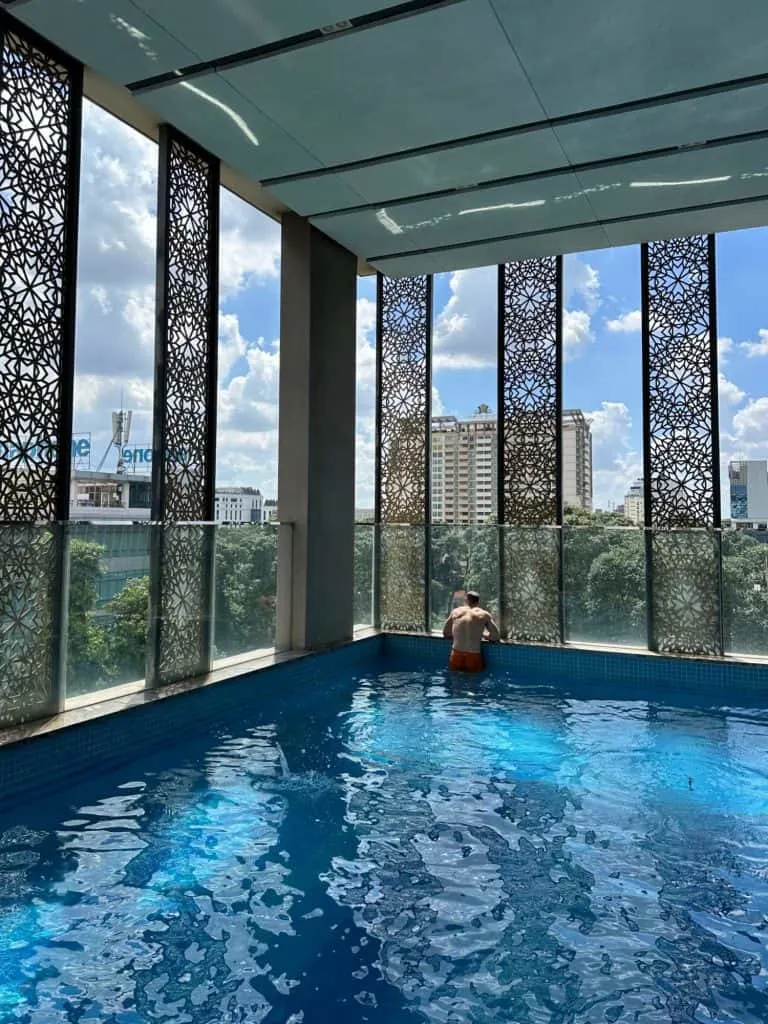 Mr Tin Box in the swimming pool at Orchids Hotel looking out over the city