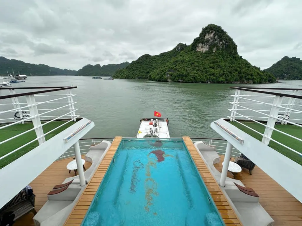 A view of the infinity pool on Mon Cheri 2 looking towards the stern where there are the green covered mountains of Ha Long Bay