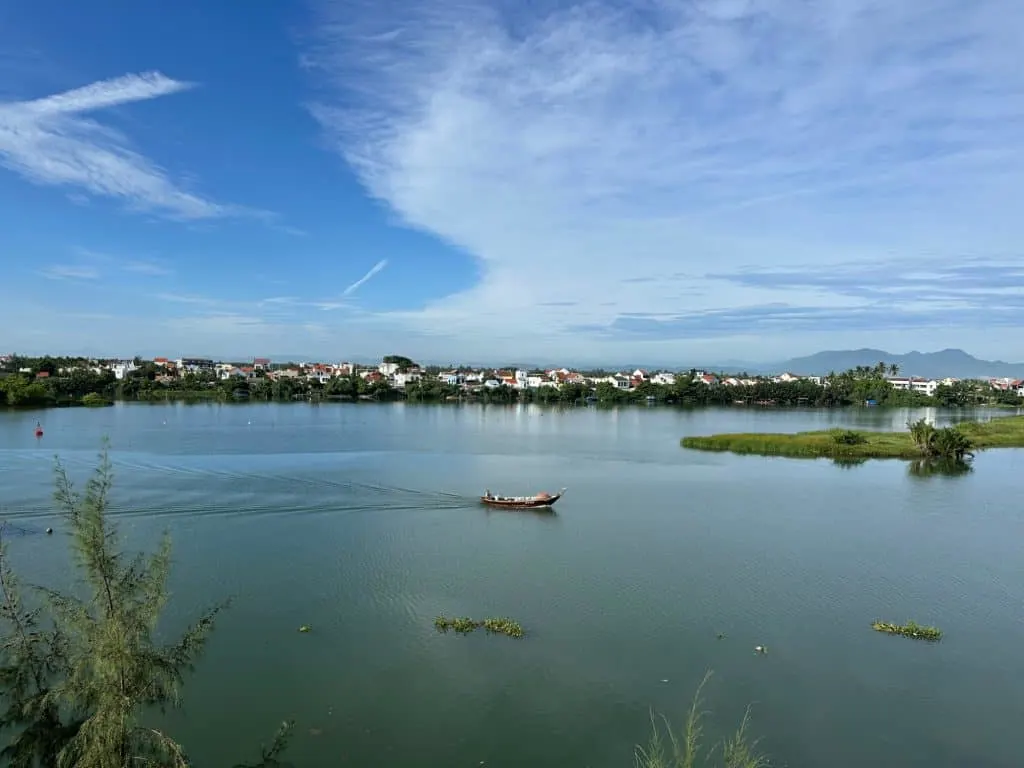 The view from out hotel room at Lantana Riverside Hotel in Hoi An. A small boat sails up stream