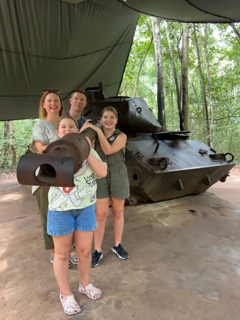 Our family posing with a captured American tanks at the Ben Dinh Cu Chi Tunnels