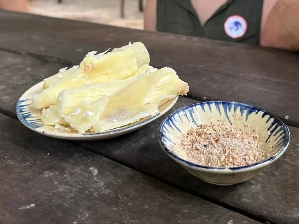 A plate of tapioca next to a bowl of sugar and chilli