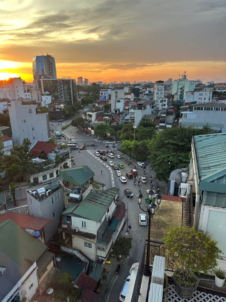 The sunset view from Acoustic Hotel & Spa's Sky Bar. The streets of Hanoi's Old Quarter below are busy with traffic