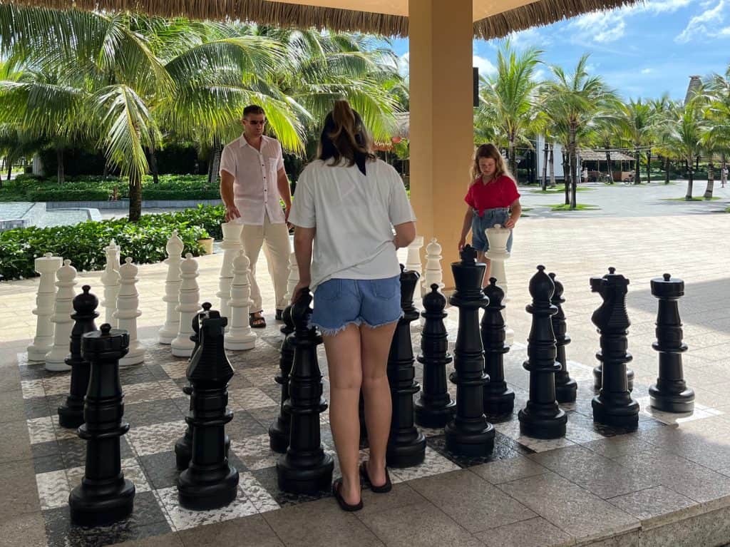 Mr Tin Box playing a garden sized game of chess with our daughters