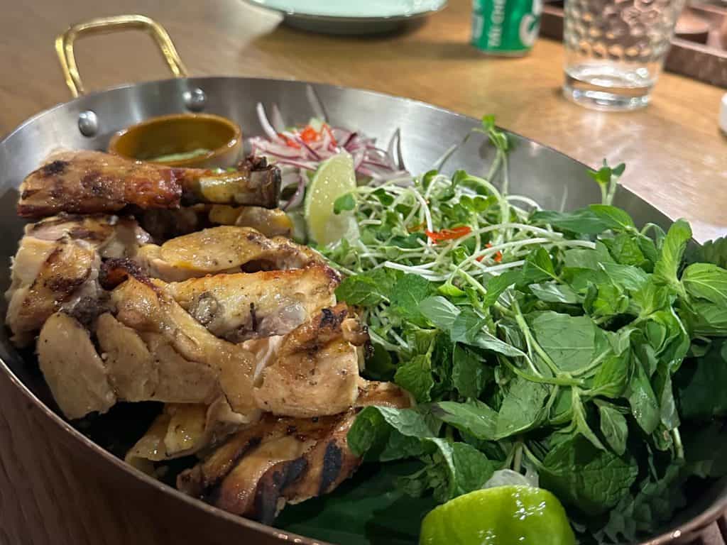 A plate of grilled chicken and salad