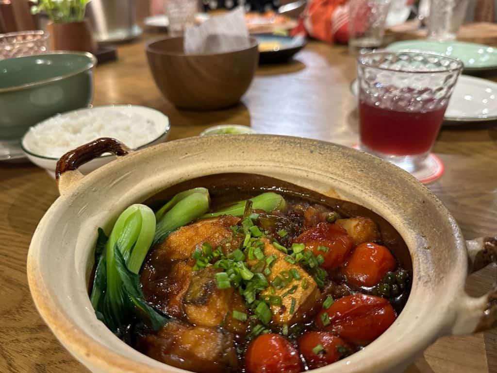 A clay pot of fish and vegetables