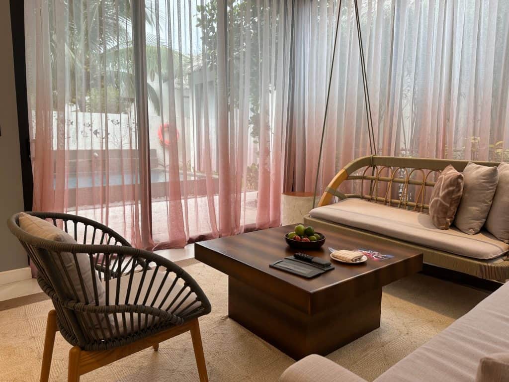 Rattan furniture in the living space of our villa overlooking the private pool