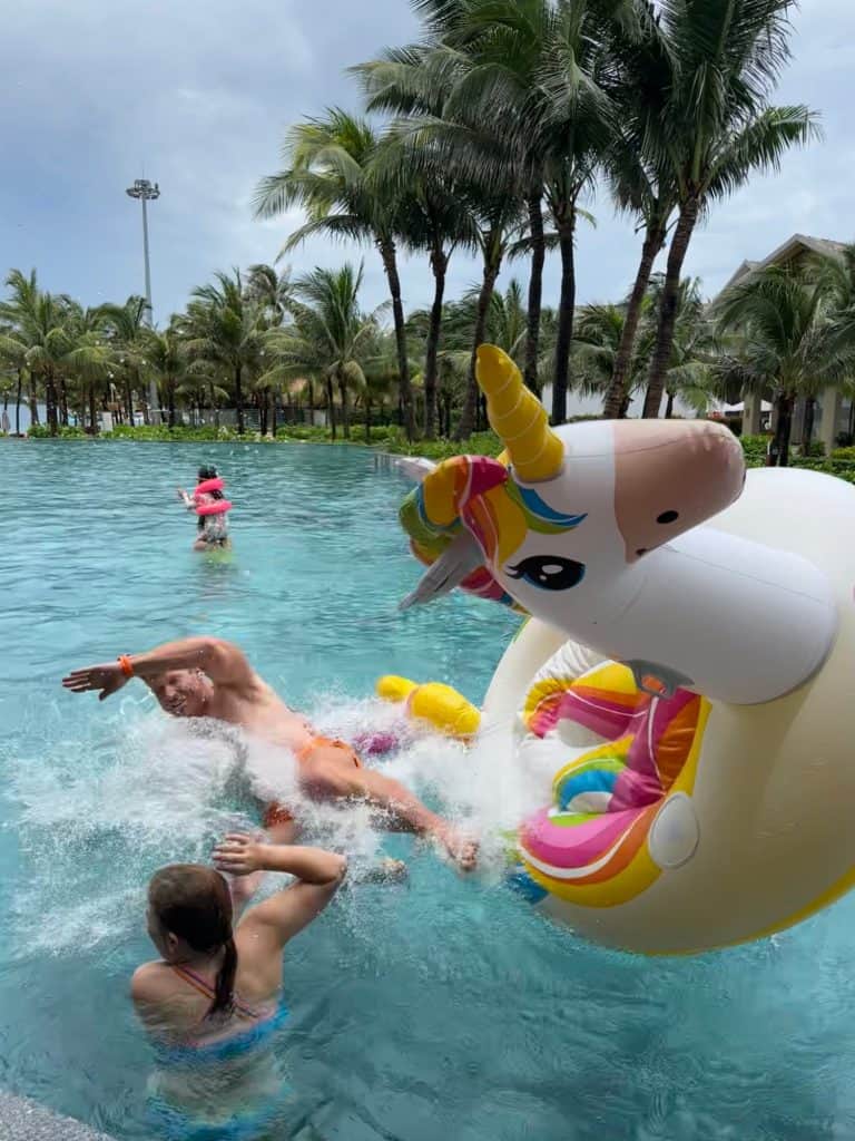 Mr Tin Box falling off an inflatable unicorn in the pool