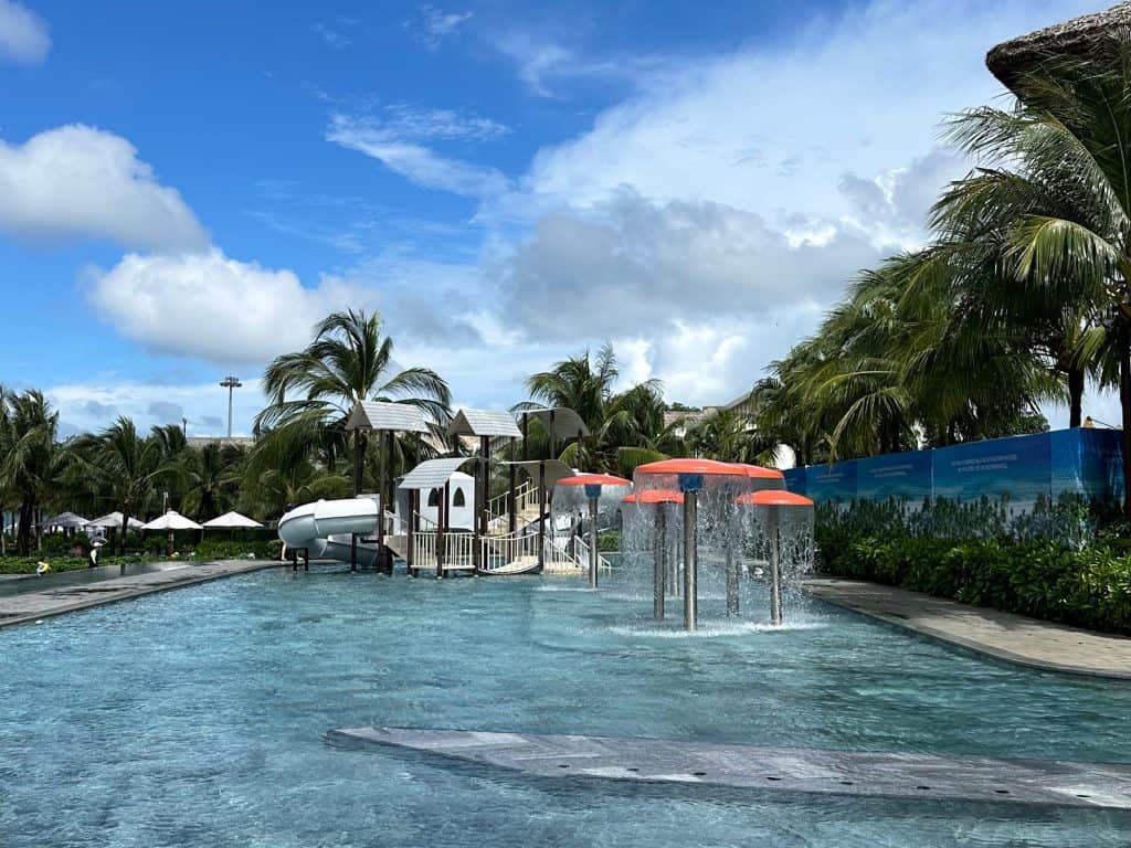 A shallow children's pool with slides and water features