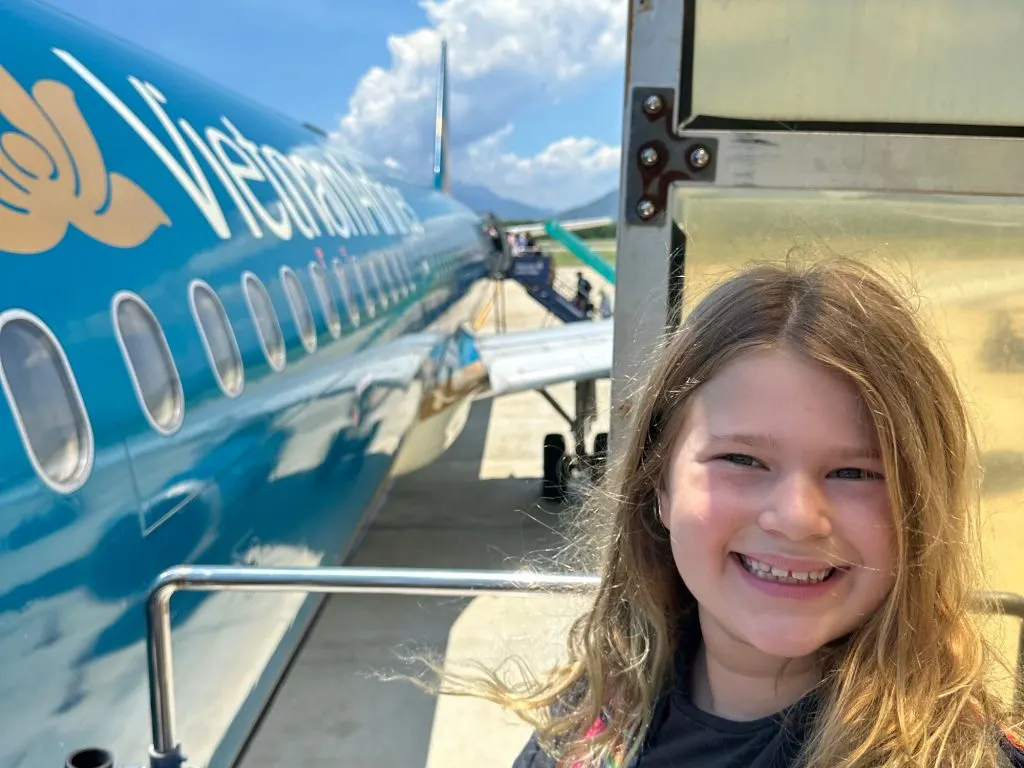 Our nine-year-old at the top of the stairs boarding a Vietnam Airlines plane