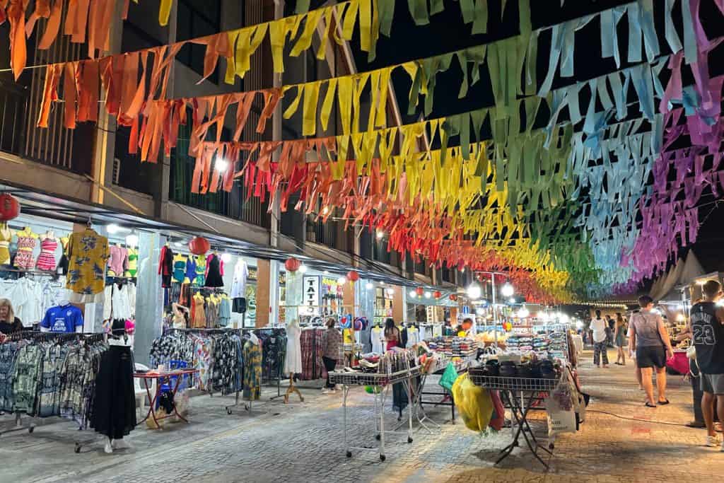 Colourful bunting hang over clothing stalls in Ao Nang Night Market