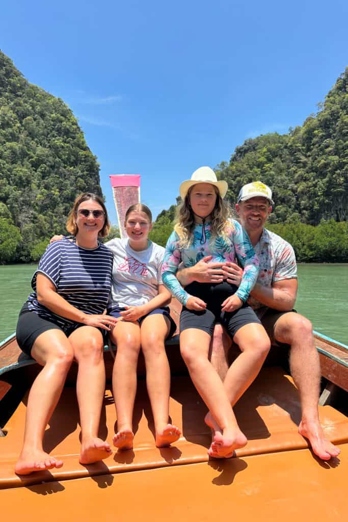 My family and I posing for a photo at the front of the longtail that took us to Hong Island in Thailand