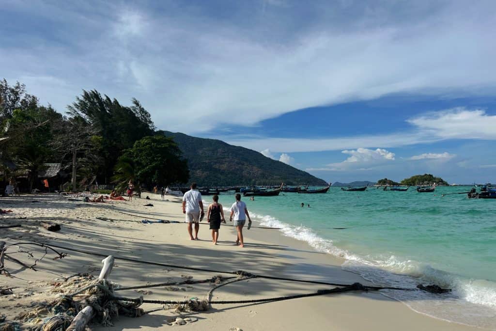 My family walking along a white sand beach on Ko Lipe in Thailand