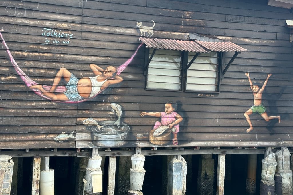 Street art on the side of a home on Chew Jetty in Penang, Malaysia. The art is called 'Folklore by the Sea'