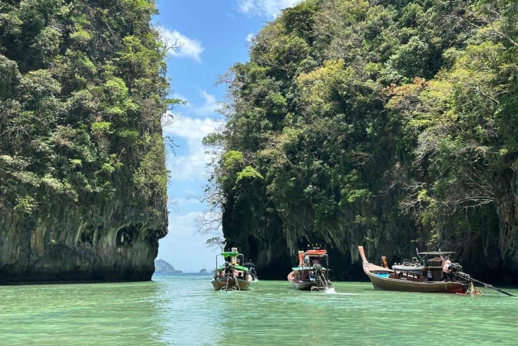 Longtail boats lining up to sail through the narrow exit to the lagoon on Hong Island