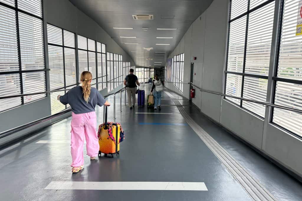 My family walking down an internal walkway at Penang train station