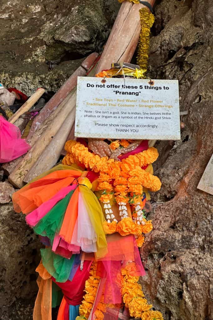 A close up of a sign in Phra Nang Cave telling visitors what kinds of offering they can and can't make here. The cave is full of phallic relics