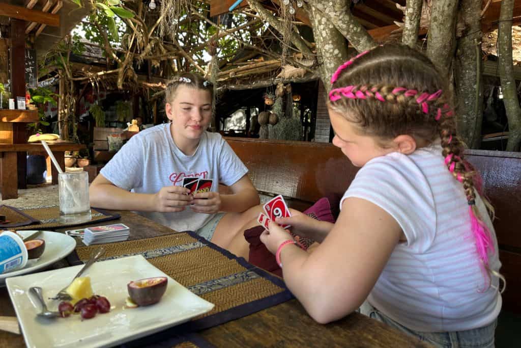 My daughters playing cards after breakfast at Lipe cafe in Koh Lipe, Thailand