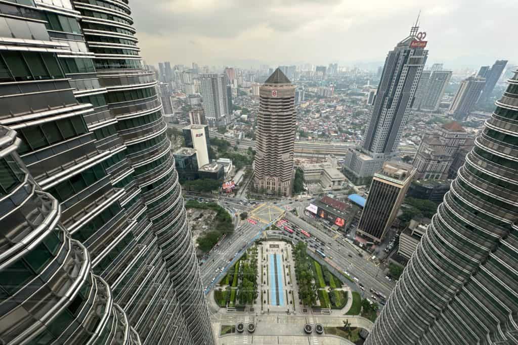 Panoramic cityscape of Kuala Lumpur featuring iconic skyscrapers and urban architecture.