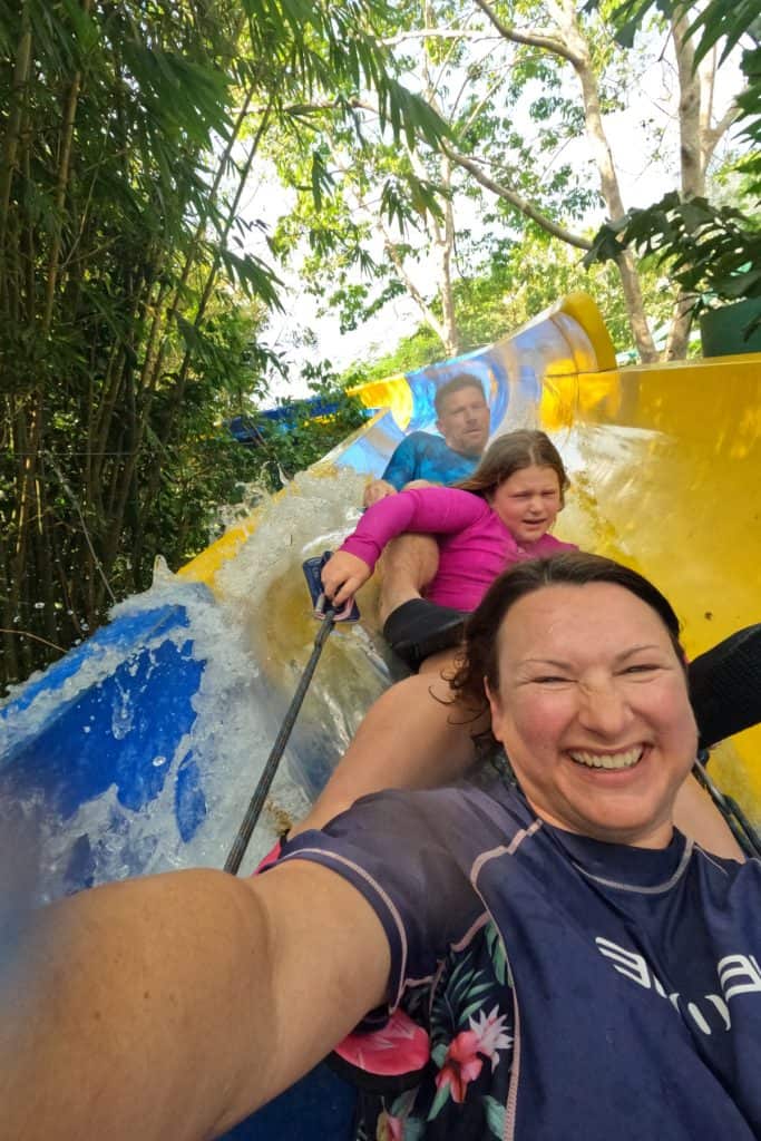 My family and I riding a tube slide at Escape theme park in Penang