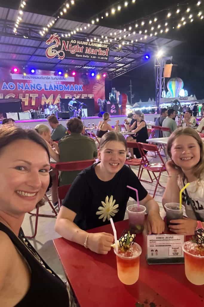 Me and my daughters sat at a table in the main seating area of Ao Nang Landmark Night Market