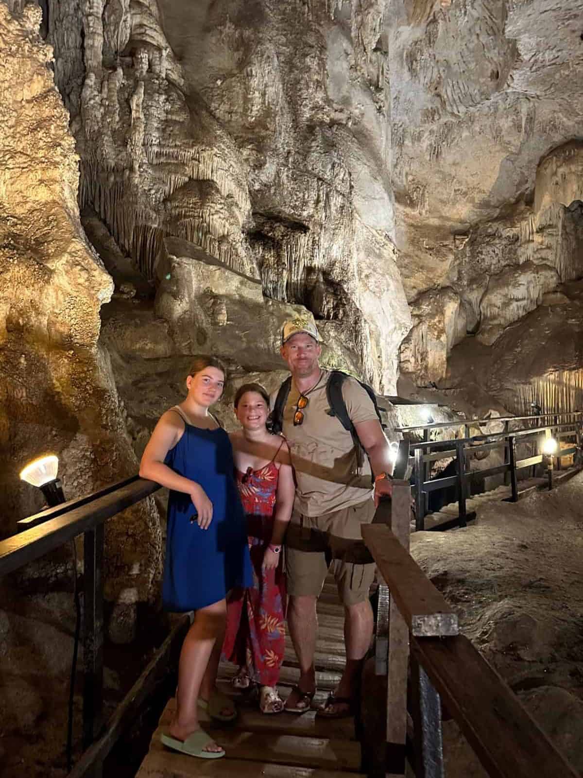 M family posing for a photo in Tham Pranangnai - the Diamond Cave in Railey. There are stalactites behind them