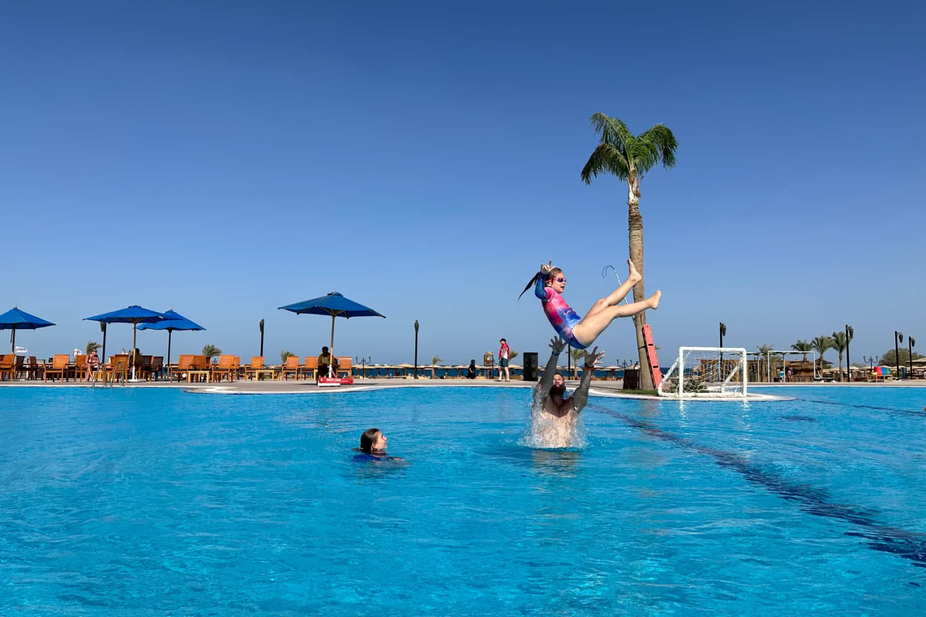 Mr Tin Box in the pool at Mercure Hurghada with his daughters. He is throwing one of them over his head.