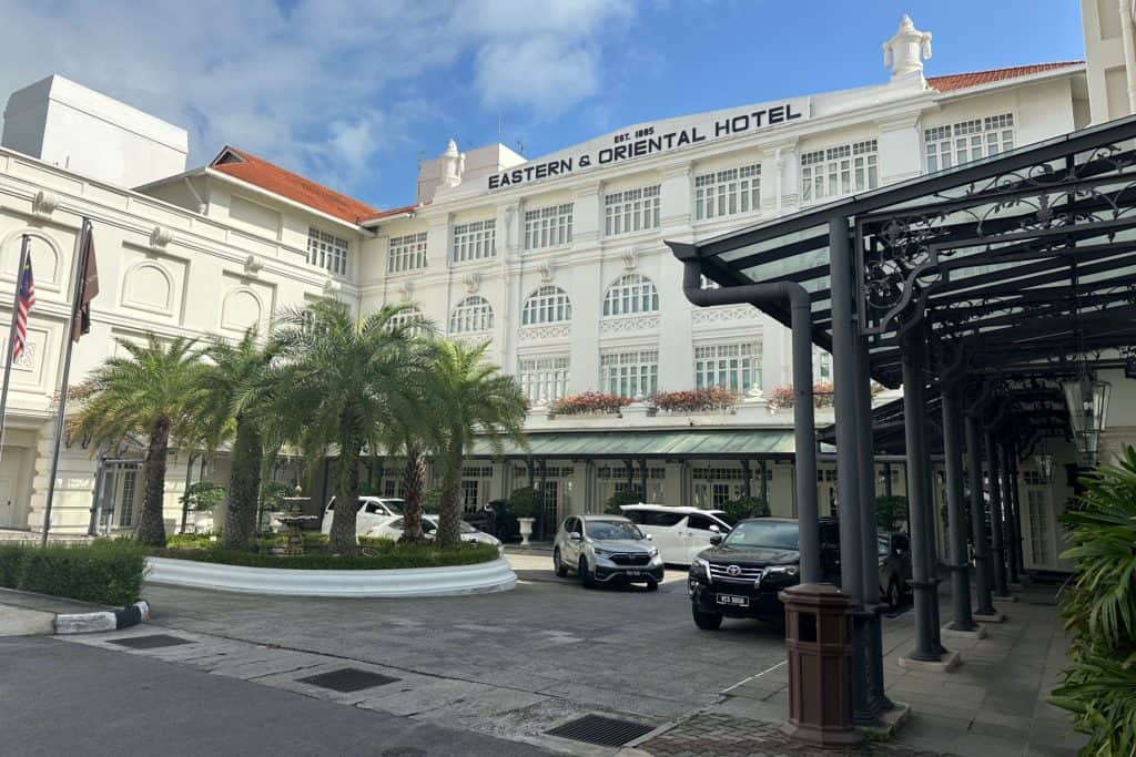 The white-washed front facade of the heritage wing of the colonial Eastern & Oriental Hotel in Penang