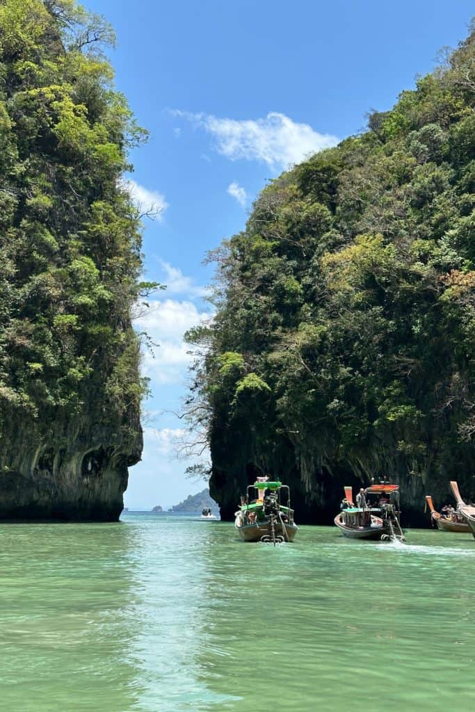 Longtail boats lining up to sail through the narrow exit to the lagoon on Hong Island
