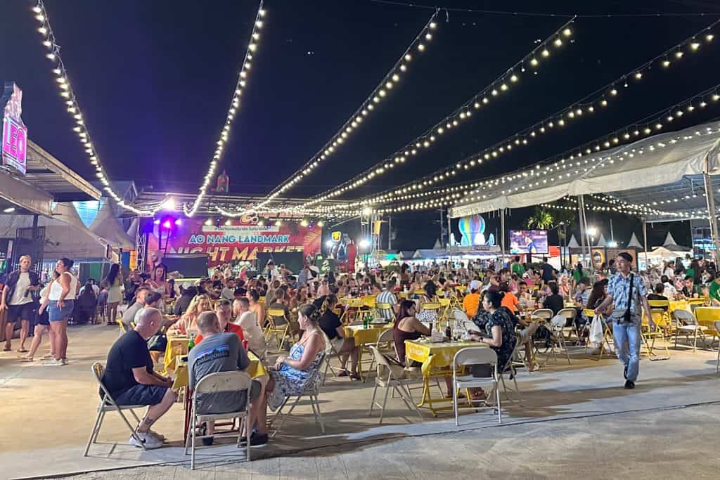 People enjoying the night time atmosphere at Ao Nang Landmark Night Market in the main seating area