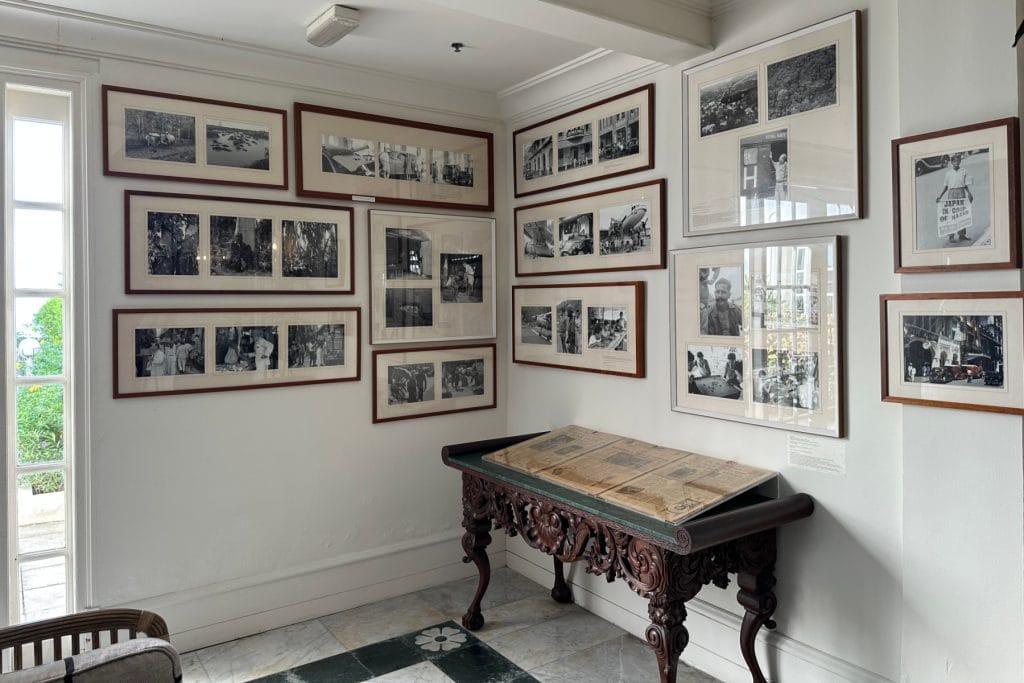 Old photos in frames on a wall in a communal area of the E&O hotel