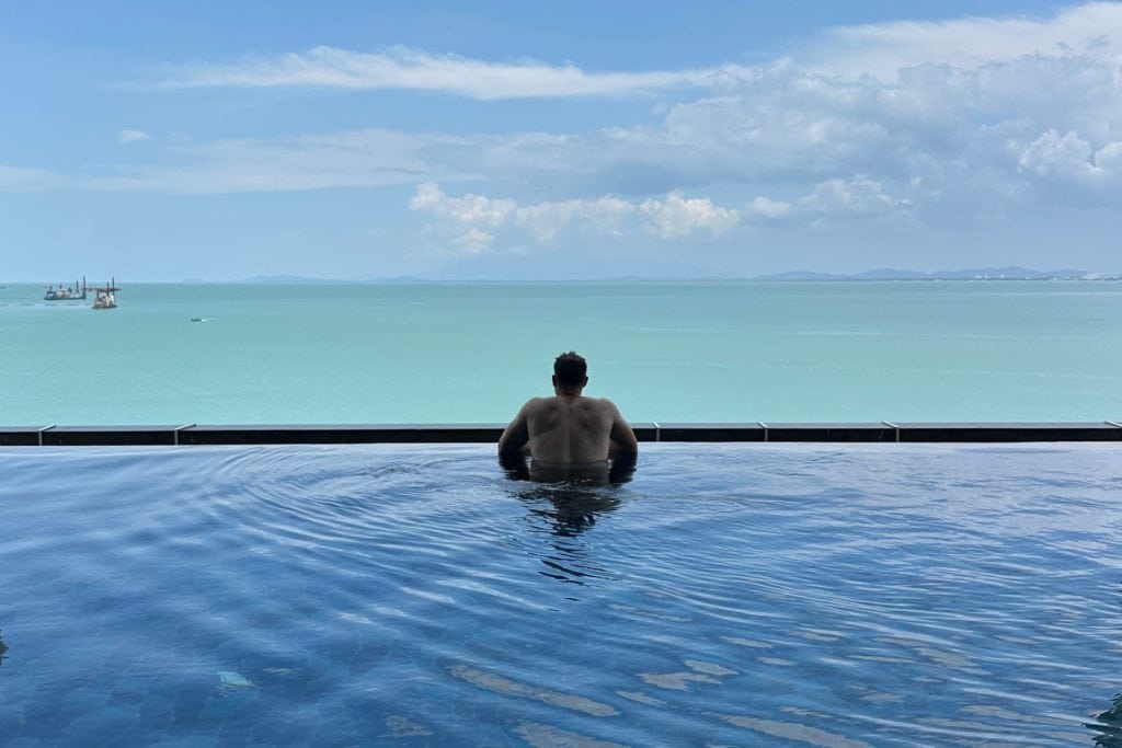 My husband looking out to sea from the rooftop infinity pool on the sixth floor of the E&O hotel in Penang