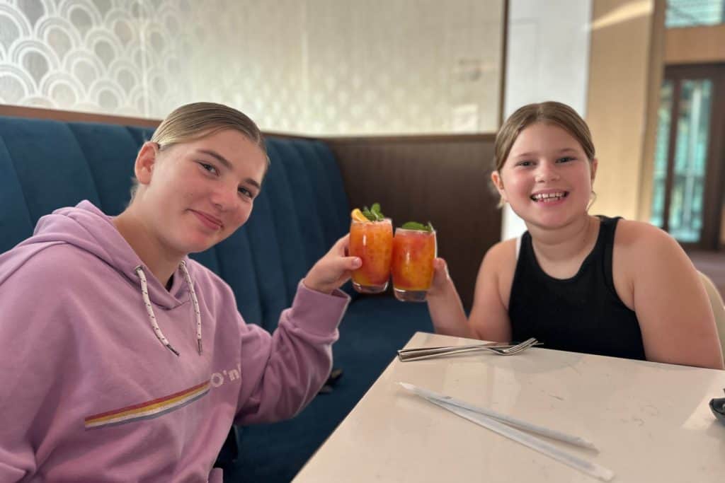My daughters toasting with glasses of fruit juice in the Imperial Club Lounge at the Atlantis The Palm Hotel