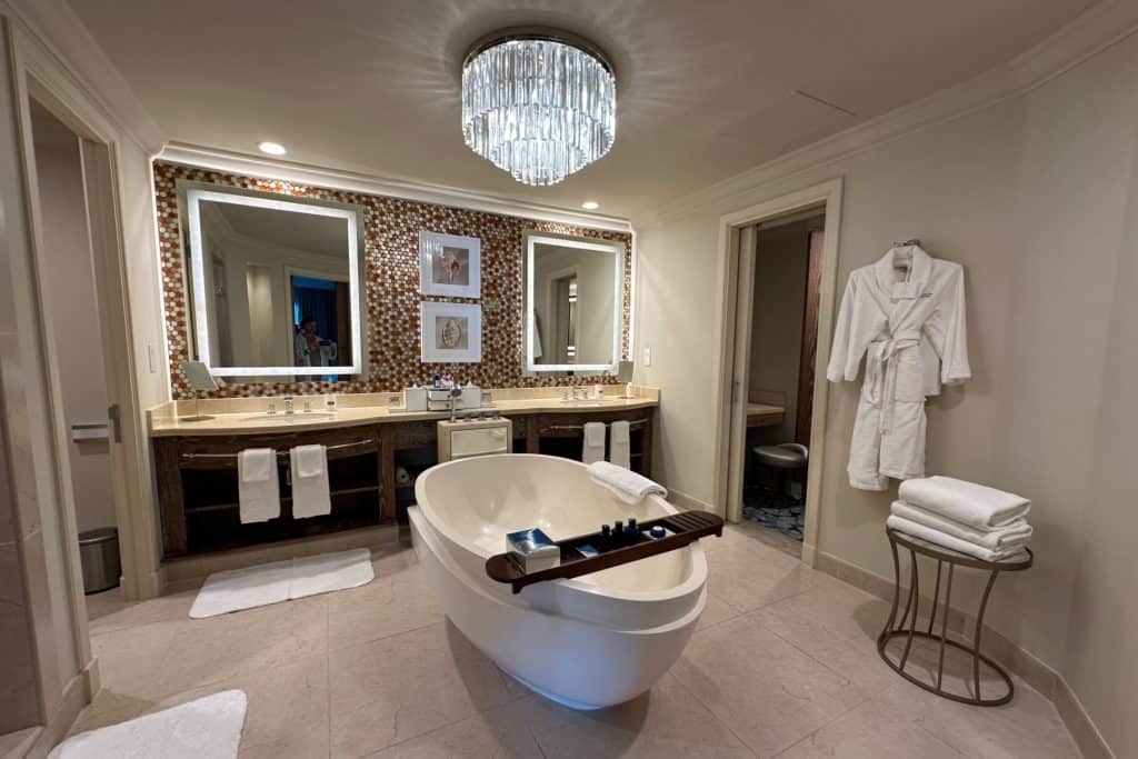 The huge bathroom with twin sinks and a freestanding bath in the Terrace Suite room at Atlantis