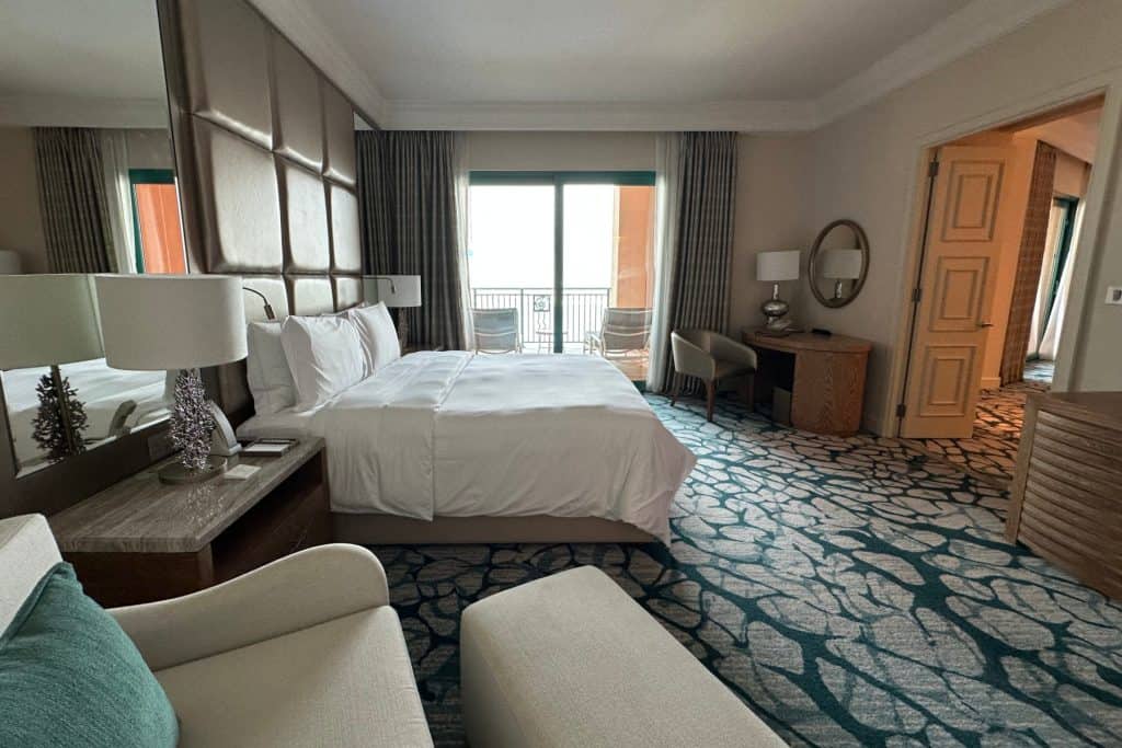 The master bedroom in our Terrace Suite. The photo is looking towards the patio window across a large double bed