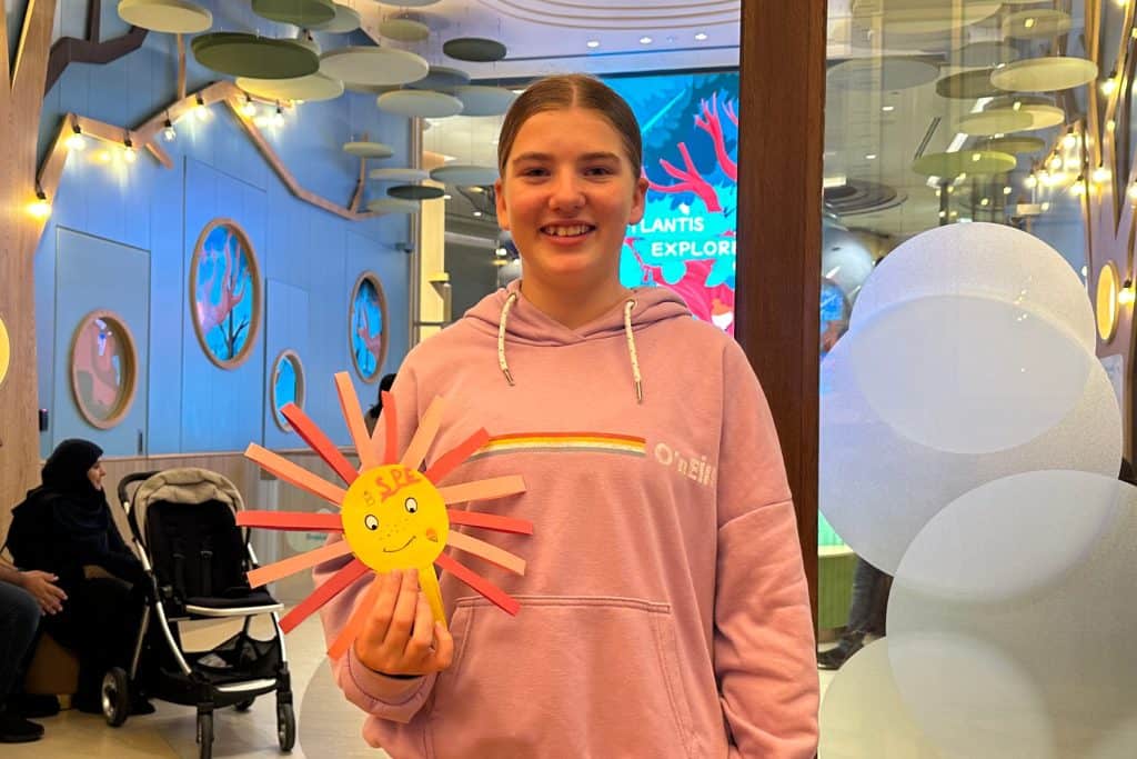 My 12-year-old holding a piece of art she created at the Explorers Club at the Atlantis