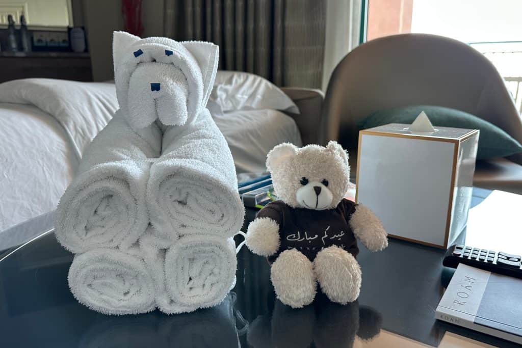One of my daughter's teddies in sat on the coffee able next to a dog made of towels