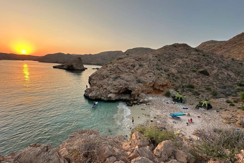 Tents pitched on a small beach on the rocky Bander Khayran coastline to the south of Muscat in Oman
