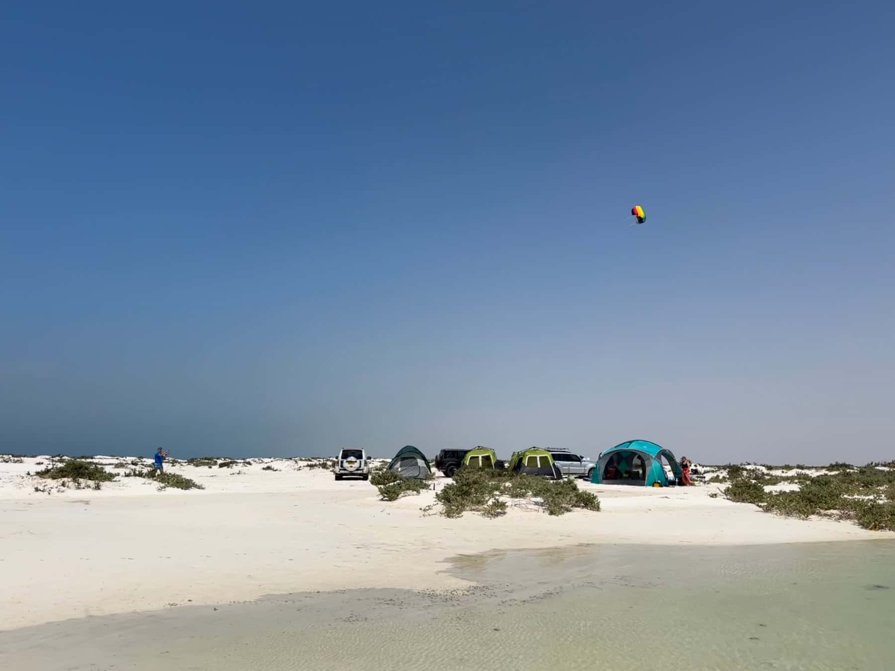 Tents pitched on a white sand beach at Barr Al Hikman in Oman