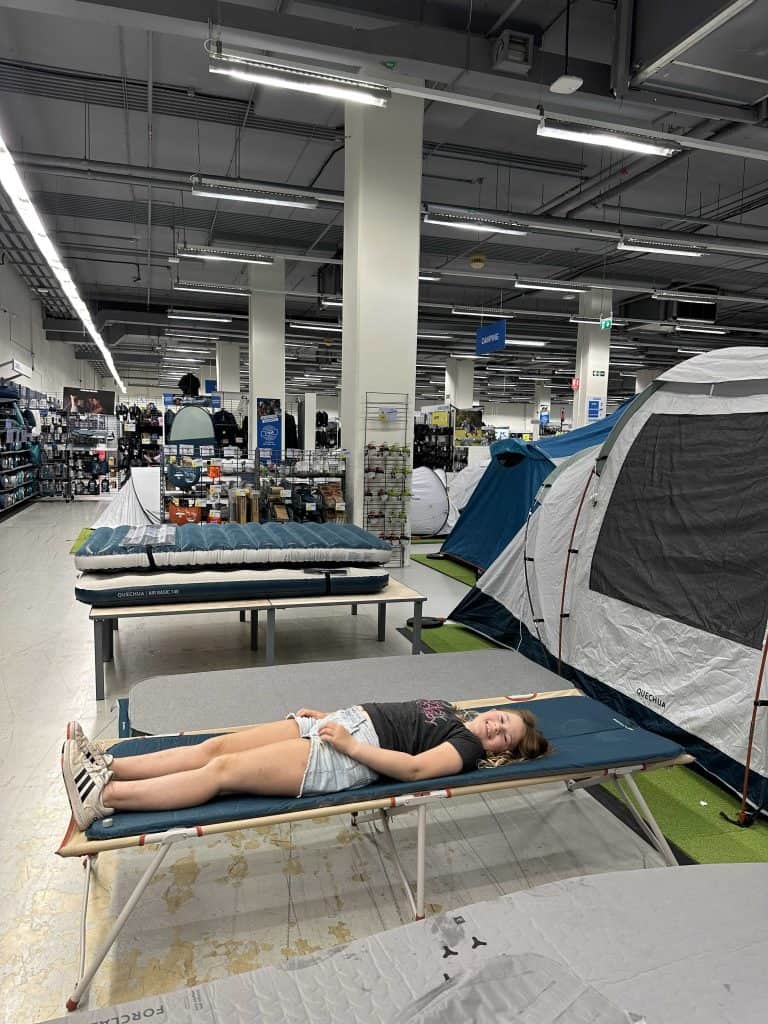 The 10-year-old laying on a camping bed in the Decathlon outdoor shop