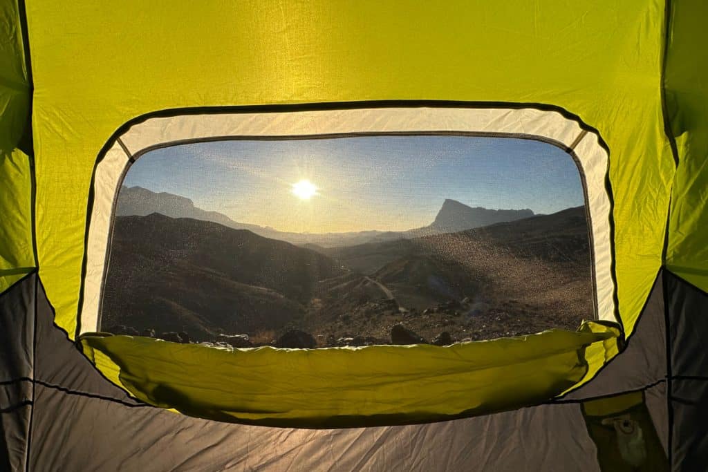 A view of Jebel Misht through the mesh window of our 