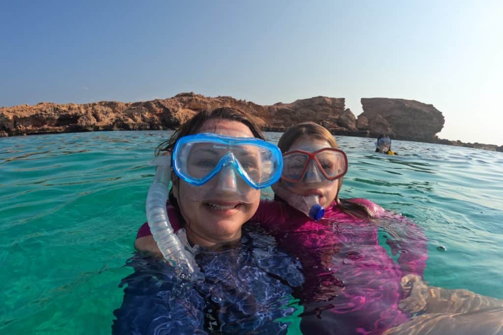 My daughter and I wearing snorkel masks in the sea at the Daymaniyat Islands