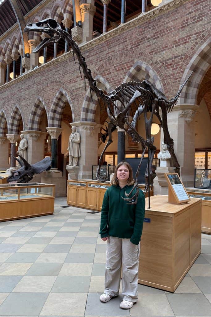 My 10-year-old stands underneath a dinosaur skeleton at the Natural History Museum in Oxford