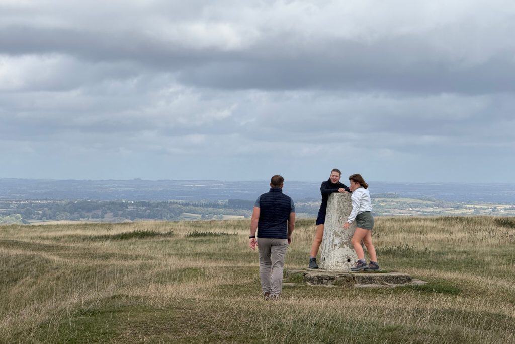 My family at the Trig point at the top of White Horse Hill with a view across the West Oxfordshire, Wiltshire and Buckinghamshire countryside in the background