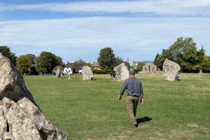 My husband walking through the Neolithic stones at Avebury in Wiltshire