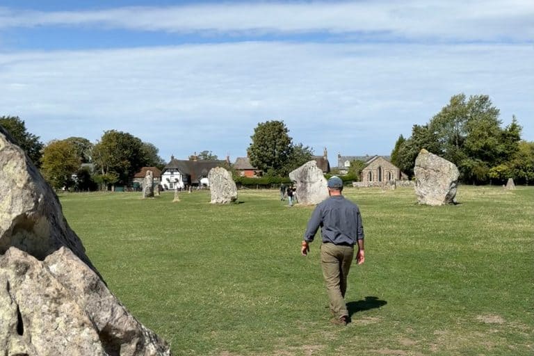 My husband walking through the Neolithic stones at Avebury in Wiltshire